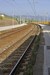 Fototapeta na wymiar Tracks and electric cables of a small Italian railroad station