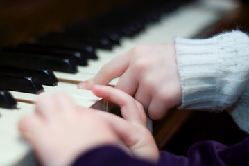 Two children playing piano