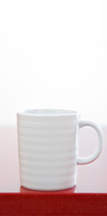 Cup on a red table