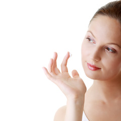 Obraz na płótnie Canvas Woman applying moisturizer cream on face