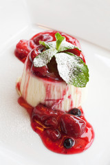 panna cotta dessert with wild berry sauce