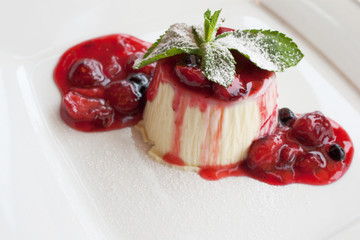 panna cotta dessert with wild berry sauce
