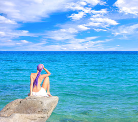 Beautiful girl meditating on the beach