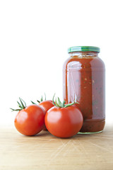 Tomato Sauce and Ripe Tomatoes on Wood