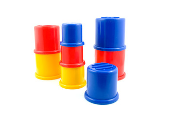 stacked plastic toys over white background