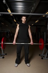 Fototapeta na wymiar a male bodybuilder working out in gym