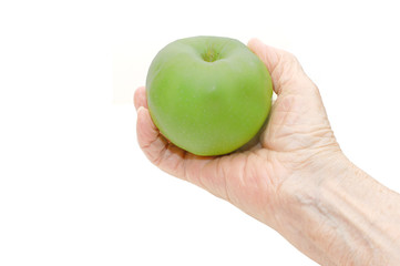 Hand of the elderly lady holding an apple