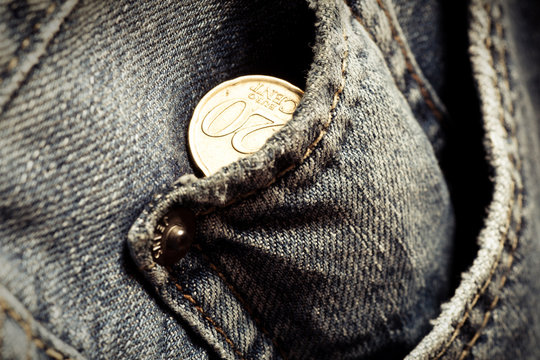 Jeans pockets with twenty cents coins