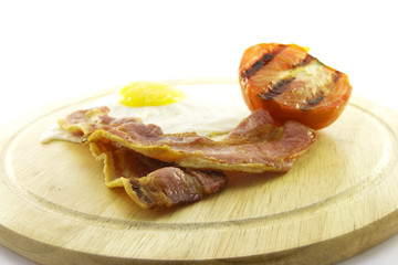 Bacon, Eggs and Tomato on Wooden Plate