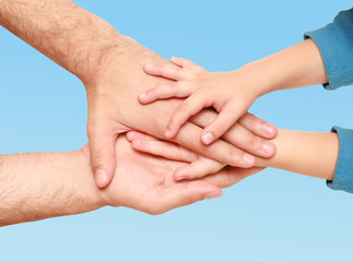 hands of the child in the hands of an adult male