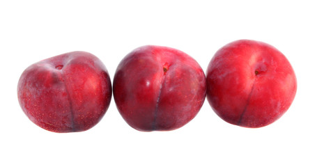Red large plums isolated.