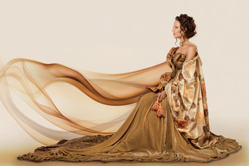 Woman sitting in a formal full flowing gown