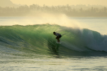 Backlit surfer in barrel, Mentawai Islands, Indonesia