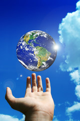 globe of planet earth above a man hand