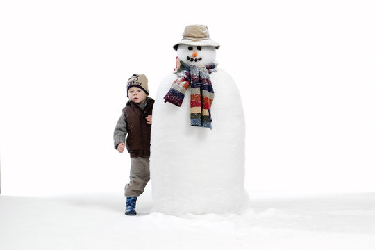 Isolated Young Boy Building Snowman