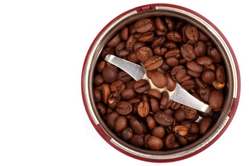 Coffee grinder with coffee grains. The top view