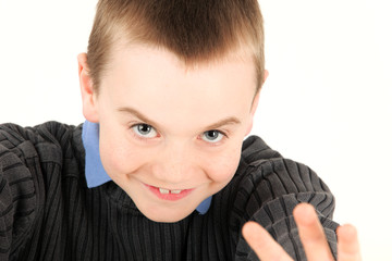 Portrait of young boy waving, studio shot