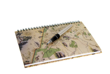 Travel diary with a pen isolated against a white background