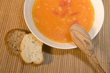 Soup with garlic and tomatoes in a plate.