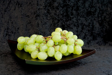 bunch of green grapes on a platter