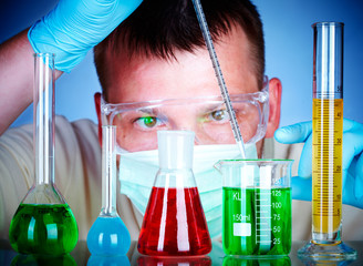 scientist in laboratory with test tubes