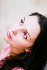 Closeup portrait of a young woman looking up