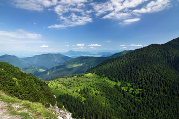 Mountain-ridge and blue sky with white clouds