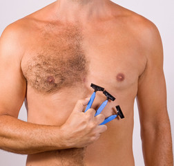 unshaved man with razor