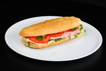 Delicious sandwich with tomatoes and chicken breast
