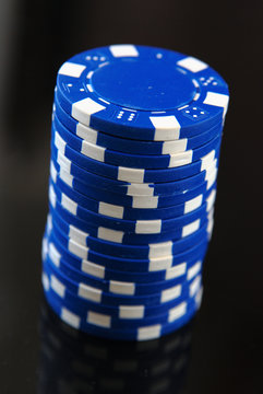 Blue casino chips on black background