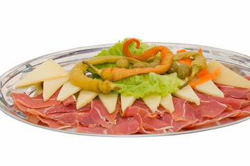 Plate of prosciutto and cheese isolated on white.