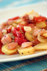 fried potatoes with tomato as warm salad