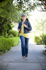 Pre Teen Girl Running Along Sidewalk