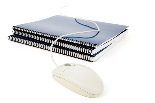 Blue school textbook and computer mouse