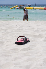 Beach slippers in the sand