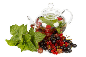 Teapot with fruit tea and green leaves