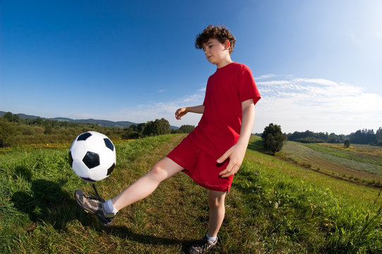 Boy playing football outdoor