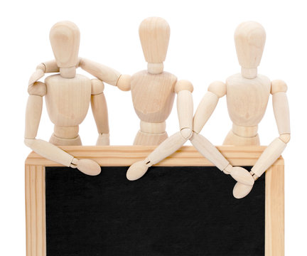Trois pantins debout derri&egrave;re un tableau noir