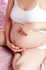 Fototapeta na wymiar Pregnant woman in bed.