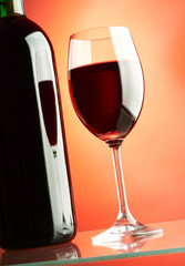 Glass and bottle of red wine.