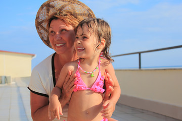 mature woman with little girl on veranda