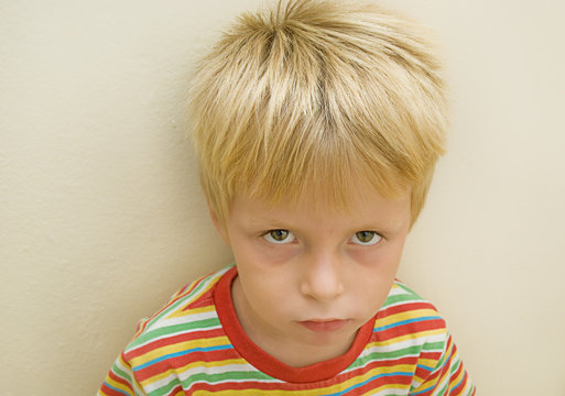three year old boy with a serious expression