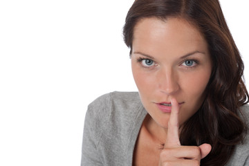 Naklejka premium Brown hair woman with with finger on lips