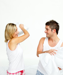 Young couple having a pillow fight