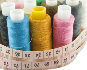 Many colorful threads with centimeters over background