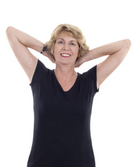 Senior woman with arms behind head stretching