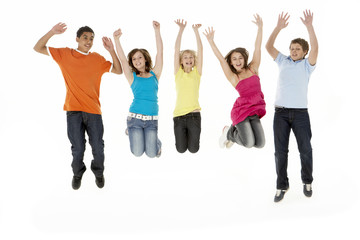 Fototapeta premium Group Of Five Young Children Jumping In Studio