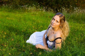 Beautiful young woman on the grass.