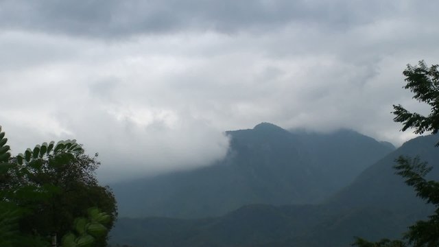 Landscape with mountains and storm clouds - time lapse