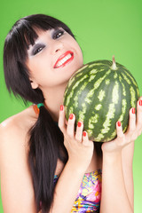 fashion woman with watermelon on the green background